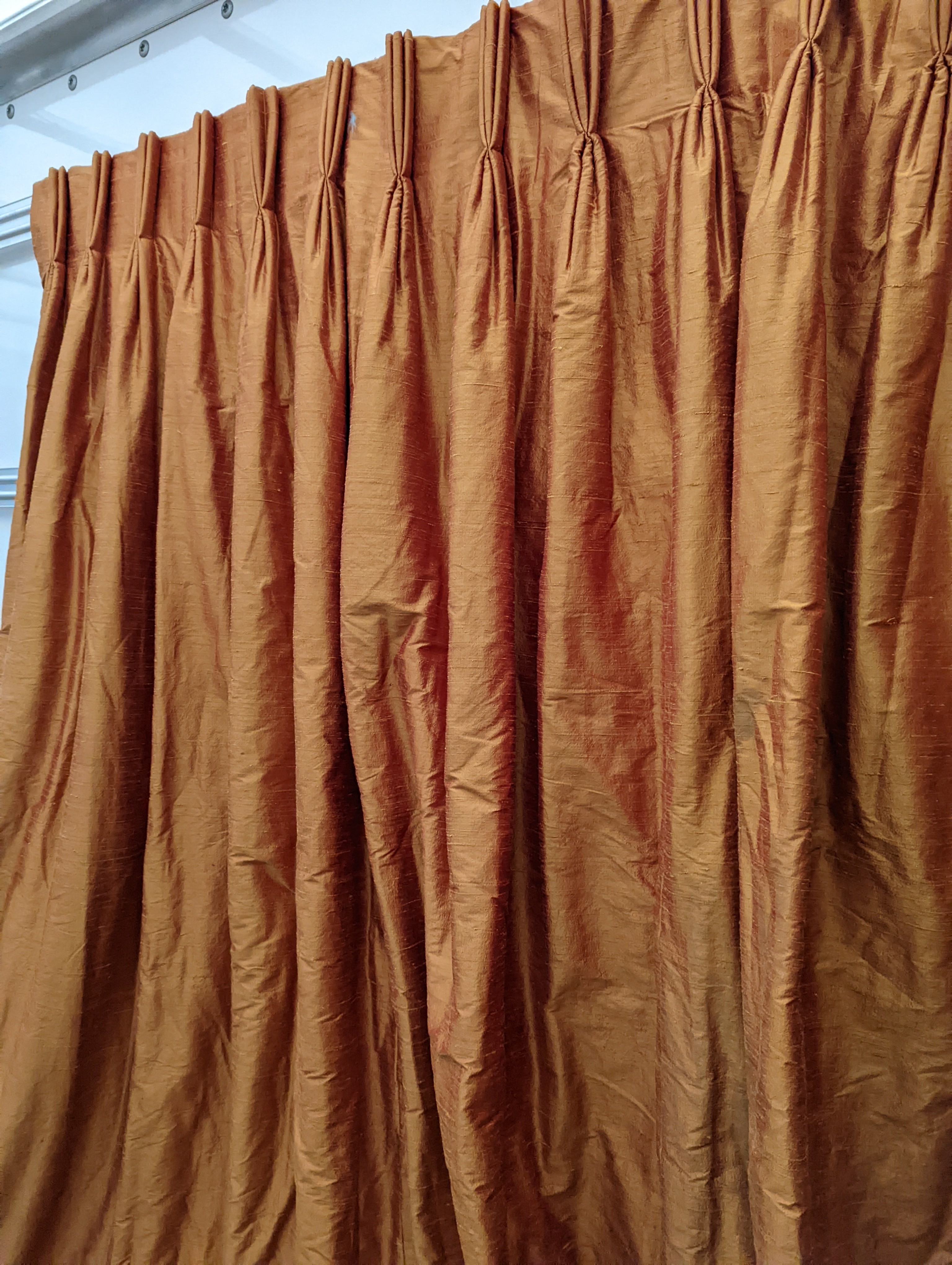 A pair of orange lined curtains. Approximate measurements: Width of top 180cm, Width of bottom 320cm Length 250cm